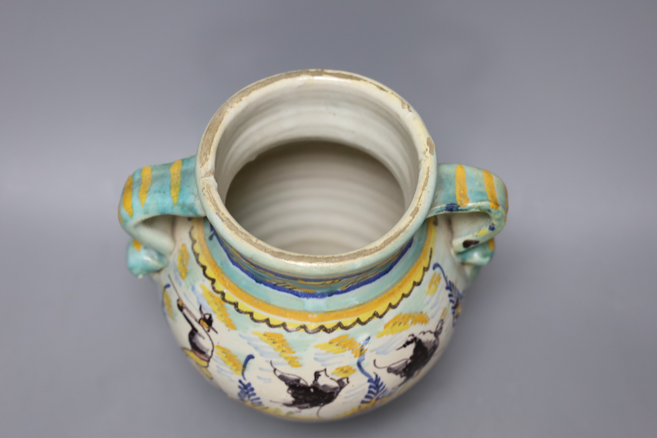 A Italian maiolica vase decorated with hares, 23cm tall